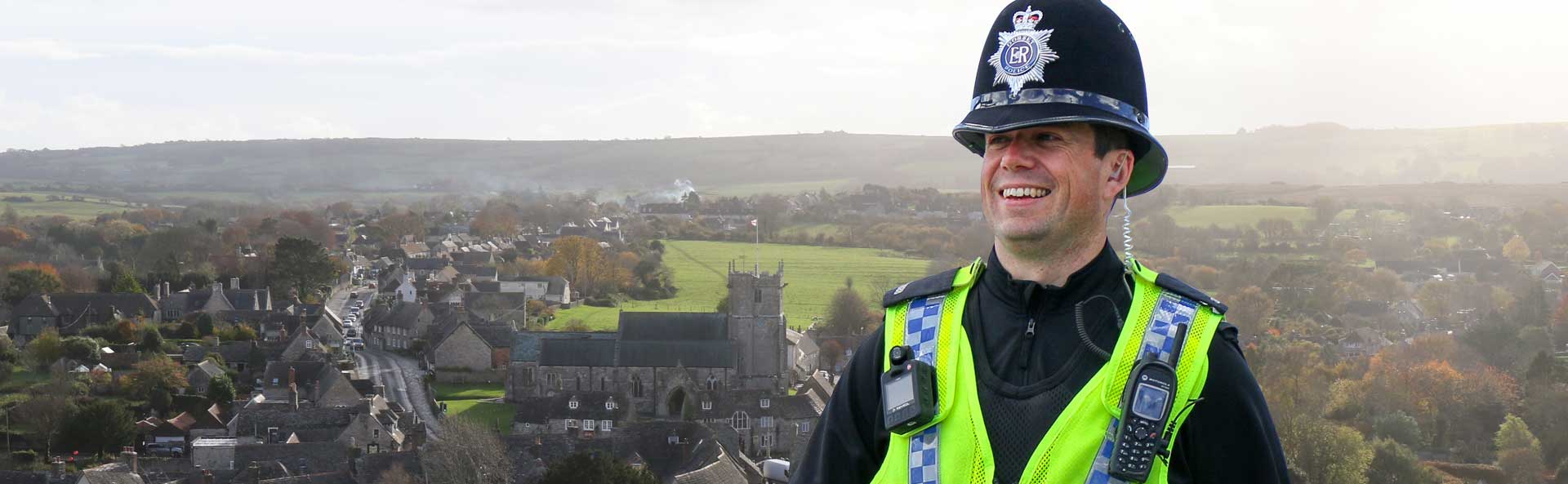 Dorset Officer infront of a Dorset Village